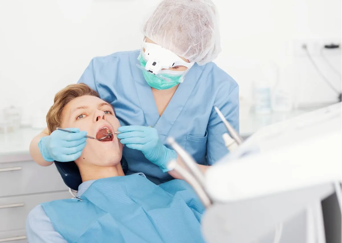 Dentist examining a patient’s teeth before applying dental sealants to help protect against cavities.