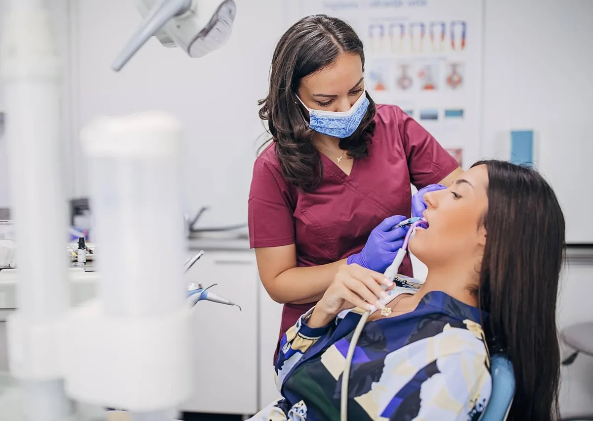 Dental professional cleaning a patient’s teeth to help prevent cavities and maintain oral health.